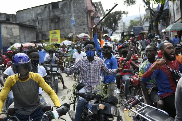 Motorcyclists unable to find gas for sale at a gas station ride in protest to the home of acting Prime Minister Ariel Henry in Port-au-Prince, Haiti, Tuesday, October 19, 2021, on the day of a strike against rising violence. (Photo by Matias Delacroix/AP Photo)