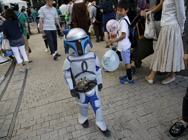 A cosplayer dressed up as Star Wars character Jango Fett walks at a Star Wars Day fan event in Tokyo May 4, 2015. (Photo by Toru Hanai/Reuters)