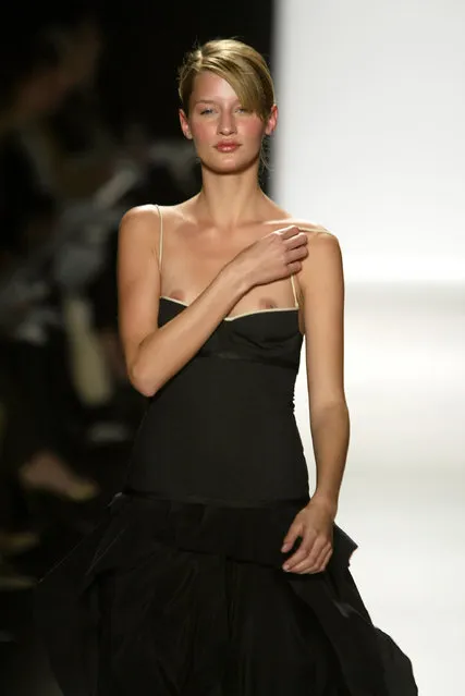 A model walks down the runway with her breast exposed at the Narciso Rodriguez Fall 2004 Fashion show on February 10, 2004 during Olympus 2004 Fashion Week at Bryant Park, in New York City. (Photo by Carlo Allegri/Getty Images)