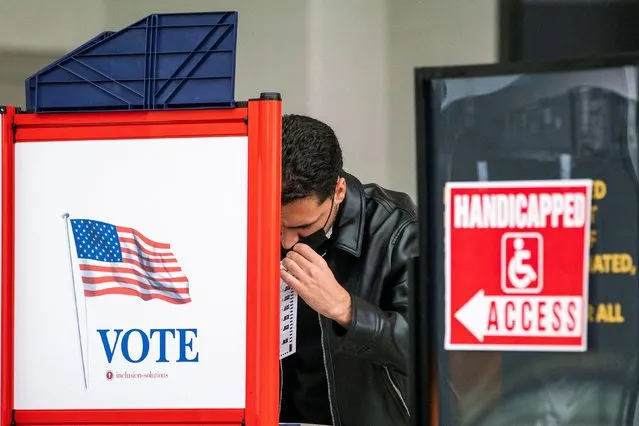 A man fills his ballot in a privacy booth while voting in the gubernatorial election in Newark, New Jersey, U.S., November 2, 2021. (Photo by Eduardo Munoz/Reuters)