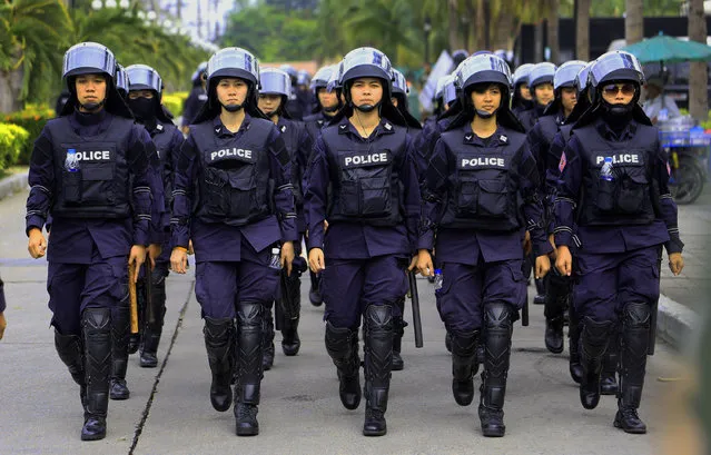 Thai policewomen  march while guarding the Command Management for Peace and Order (CMPO) Friday, February 21, 2014 in Bangkok, Thailand. Angry farmers driving hundreds of tractors called off a threatened protest at Thailand's main airport Friday, offering a reprieve to the country's embattled prime minister and to travelers fearing a repeat of a major 2008 blockade of the airport. (Photo by Wason Wanichakorn/AP Photo)