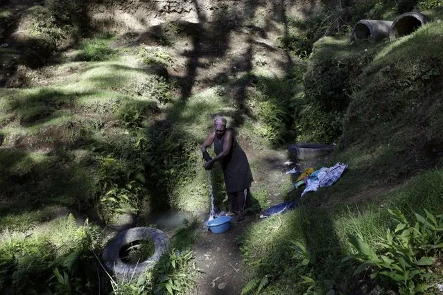 A woman does the laundry at a water source in the outskirts of Kenscoff, Haiti, February 23, 2016. March 22 marks World Water Day. (Photo by Andres Martinez Casares/Reuters)