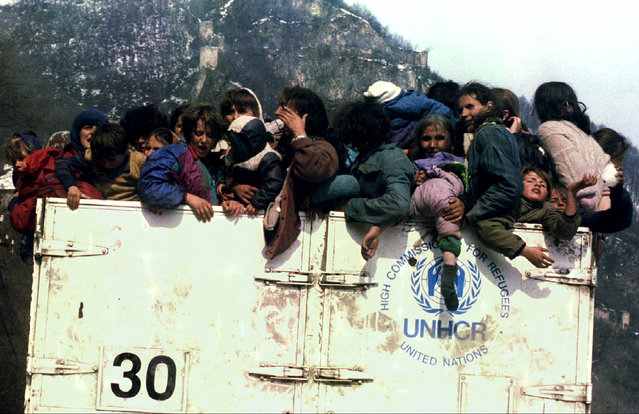 Muslim refugees in an overloaded UNHCR truck during evacuation from besieged Srebrenica, March 1993. On July 11, 1995, towards the end of Bosnia's 1992-95 war, Bosnian Serb forces swept into the eastern Srebrenica enclave, a U.N.-designated “safe heaven”. There they took 8,000 Muslim men and boys and executed them in the days that followed, dumping their bodies into pits in the surrounding forests. (Photo by Reuters)