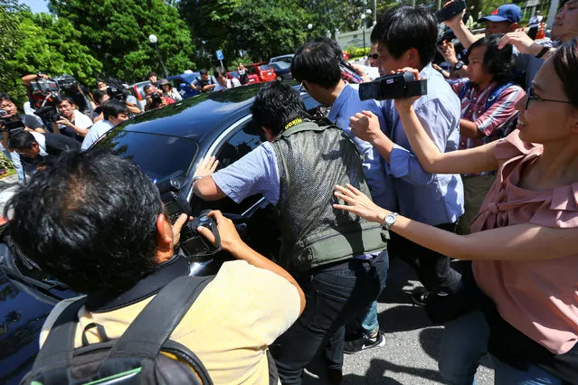 Members of the media chase a North Korean official car to ask questions at the Foreign Ministry in Putrajaya, Malaysia, February 20, 2017. (Photo by Athit Perawongmetha/Reuters)