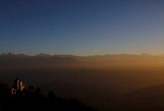 Light illuminates the mountain range and hills during the sunrise over the Nagarkot valley, Nepal December 7, 2016. (Photo by Navesh Chitrakar/Reuters)