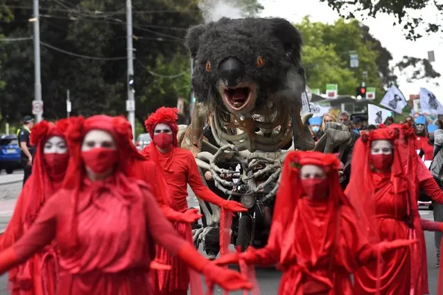 An art piece depicting a burning koala is displayed during a climate change protest in Melbourne on December 9, 2021. (Photo by William West/AFP Photo)