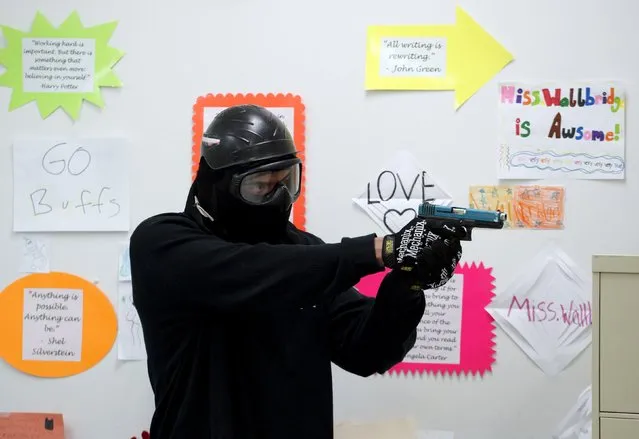 A student prepares to confront a “gunman” in a middle school classroom during an Active Shooter Response course offered by TAC ONE Consulting in Denver April 2, 2016. (Photo by Rick Wilking/Reuters)