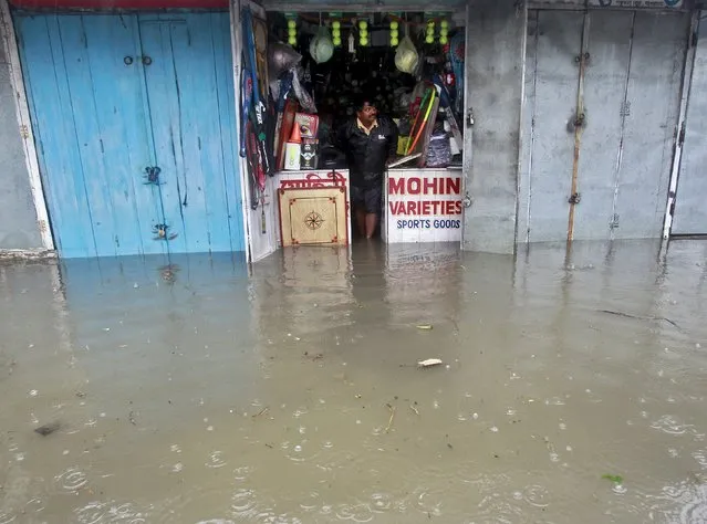 A sports merchandise vendor stands inside his flooded shop during a rain shower in Agartala, India, May 11, 2015. This year, rains in India are expected to be 93 percent of a long-term average, Earth Science Minister Harsh Vardhan said last month, after releasing the India Meteorological Department's forecast. (Photo by Jayanta Dey/Reuters)