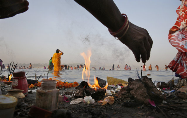 Indian Hindu devotees perform morning rituals on the banks of the Ganges River on the first day of the nine-day Hindu festival of Navratri, in Allahabad, India on April 8, 2016. (Photo by Rajesh Kumar Singh/AP Photo)