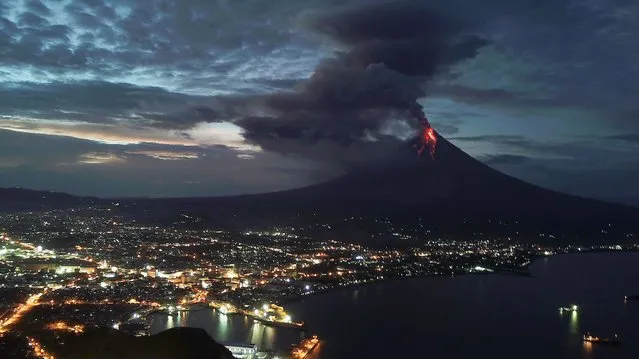 A view of Mayon Volcano erupts anew in Legaspi city, Albay province, Philippines 23 January 2018. The Philippine Institute of Volcanology and Seismology agency (PHIVOLCS) on January 22 raised the alert level for Mayon volcano amid fears of a bigger eruption over the next few hours or days. More than 26 thousand people have been evacuated to shelters in the area. “The Danger Zone is extended to eight kilometers radius from the summit vent. The public is strongly advised to be vigilant and desist from entering this danger zone”, PHIVOLCS added. (Photo by Zalrian Z. Sayat/EPA/EFE/Rex Features/Shutterstock)