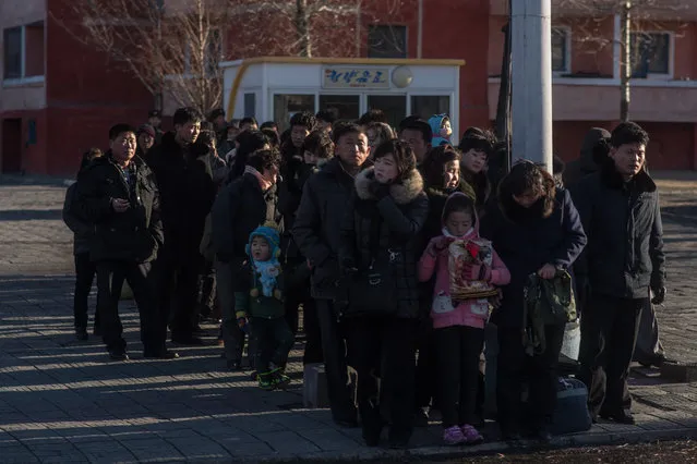 Pedestrians wait for a bus in Pyongyang on February 17, 2017. (Photo by Ed Jones/AFP Photo)