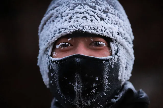 This photo taken on December 26, 2021 shows a man covered with ice during temperatures of minus 24 degrees celsius in Shenyang in China's northeastern Liaoning province. (Photo by AFP Photo/China Stringer Network)