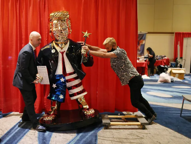 Matt Braynard (L) helps artist Tommy Zegan (R) move his statue of former President Donald Trump to a van during the Conservative Political Action Conference on February 27, 2021 in Orlando, Florida. Begun in 1974, CPAC brings together conservative organizations, activists, and world leaders to discuss issues important to them. (Photo by Joe Raedle/Getty Images)