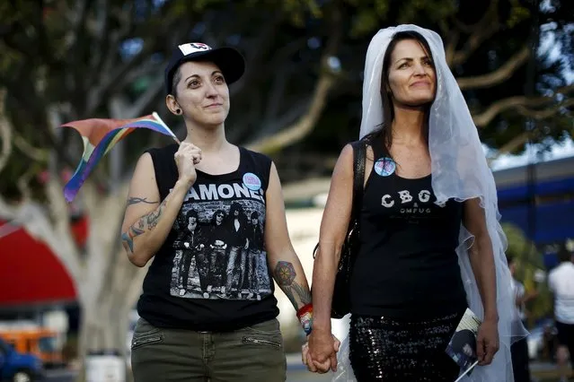 Natalie Novoa, 38, (L) walks with her wife Eddie Daniels at a celebration rally after getting married in West Hollywood, California, United States, June 26, 2015. (Photo by Lucy Nicholson/Reuters)