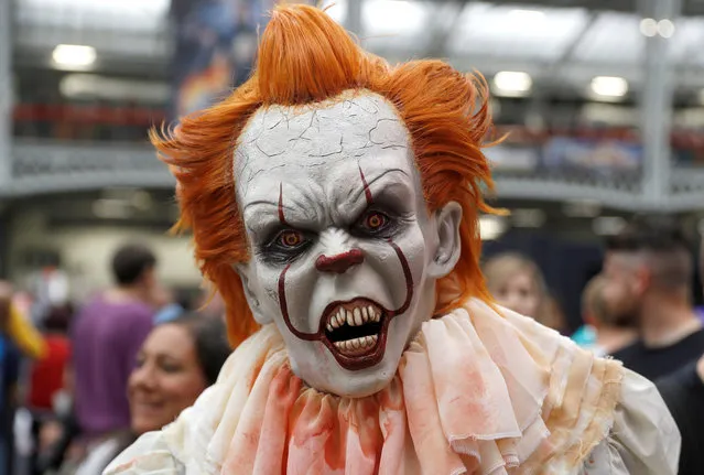 A person dressed as a Pennywise from the movie IT walks through the London Film and Comic Con event at Olympia in London, Britain, July 27, 2019. (Photo by Peter Nicholls/Reuters)