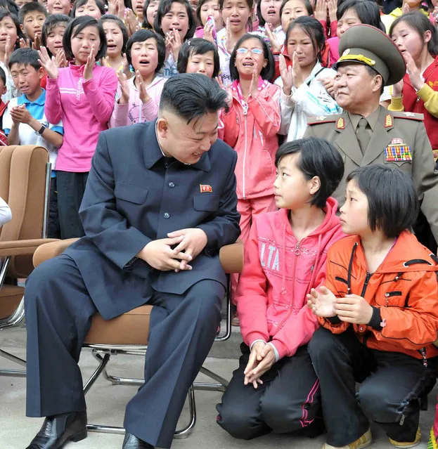 North Korean leader Kim Jong-un talks to children during a visit to the Pyongyang Myohyangsan Children's Camp situated at the foot of Mt. Myohyang in North Phyongan Province, in this photo released by North Korea's Korean Central News Agency (KCNA) on May 20, 2013. (Photo by Reuters/KCNA)