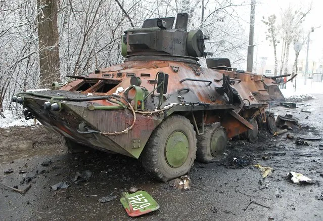 A view shows a destroyed armored personnel carrier (APC) on the roadside in Kharkiv, Ukraine on February 26, 2022. (Photo by Vyacheslav Madiyevskyy/Reuters)