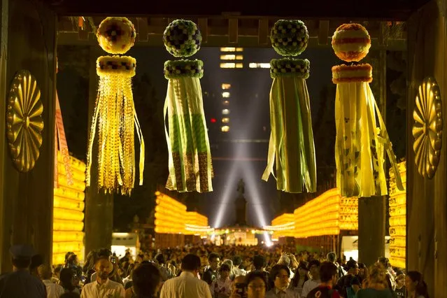 People mingle between walls of lanterns during the annual Mitama Festival at the Yasukuni Shrine in Tokyo, Japan, July 13, 2015. (Photo by Thomas Peter/Reuters)