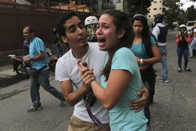 A woman screams after a man was run over by a police motorcycle during skirmishes between protesters and police at a May Day opposition march in eastern Caracas, Venezuela, Monday, May 1, 2017. (Photo by Fernando Llano/AP Photo)