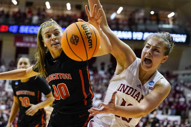 Princeton forward Ellie Mitchell (00) and Indiana forward Aleksa Gulbe (10) reach for the ball as they go for a long rebound in the second half of a college basketball game in the second round of the NCAA tournament in Bloomington, Ind., Monday, March 21, 2022. Indiana defeated Princeton 56-55. (Photo by Michael Conroy/AP Photo)