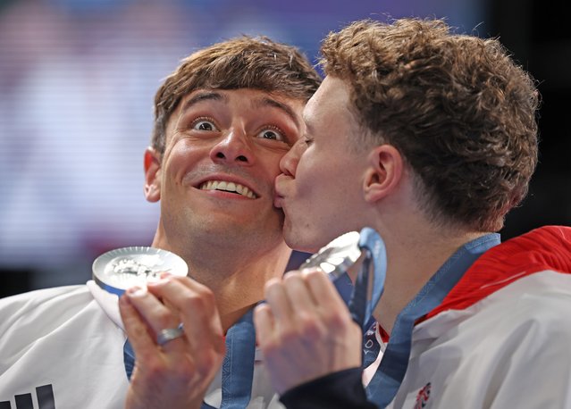 Silver Medalists Thomas Daley and Noah Williams of Team Great Britain celebrate as they pose following the Diving medal ceremony after the Men’s Synchronised 10m Platform Final on day three of the Olympic Games Paris 2024 at Aquatics Centre on July 29, 2024 in Paris, France. (Photo by Marc Aspland/The Times)