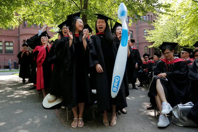 Dental School students Helen Yang (L) and Xinli Liu react after receiving their degrees during the 365th Commencement Exercises at Harvard University in Cambridge, Massachusetts, U.S. May 26, 2016. (Photo by Brian Snyder/Reuters)