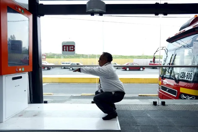 A metrobus driver performs squats at Rio de los Remedios metrobus station in Mexico City, July 23, 2015. To combat growing obesity, lawmakers have introduced a new campaign encouraging physical activity. This machine, installed in 21 metrobus stations around the city, asks its user to do 10 squats, and when all ten are performed correctly, it prints out a free ticket. (Photo by Edgard Garrido/Reuters)