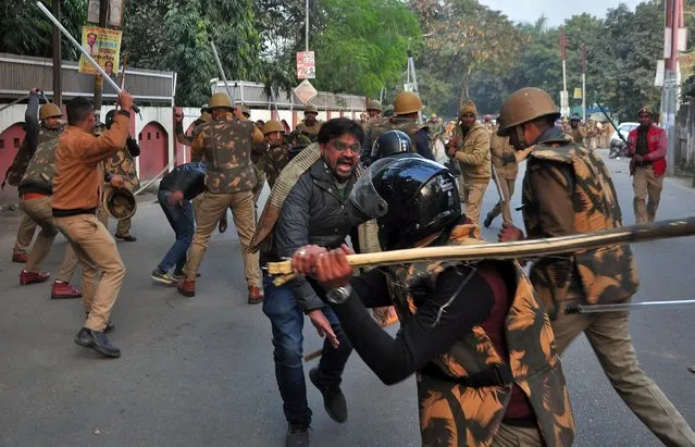 Police officers wield sticks against demonstrators during a protest against a new citizenship law, in Lucknow, India, December 19, 2019. (Photo by Reuters/Stringer)