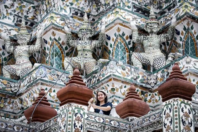 A tourist visits Wat Arun, the Temple of Dawn, in Bangkok, Thailand, 04 May 2022. Thailand has lifted arrival restrictions for fully vaccinated travelers arriving by air starting 01 May 2022. The move to ease up on travel restrictions is expected to give a much needed boost to the tourism sector. (Photo by Diego Azubel/EPA/EFE)
