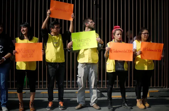Volunteers of Amnesty International hold a sign that reads, “Save the IACHR” (Inter-American Human Rights Commission), during a demonstration demanding the Organisation of American States (OAS) increase the budget they assigned to IACHR, outside the Foreign Affairs building, in Mexico City, Mexico, June 8, 2016. (Photo by Edgard Garrido/Reuters)