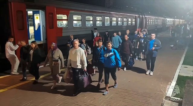 In this photo released by Russian Emergency Ministry Press Service on Friday, August 9, 2024, residents from the Kursk region arrive in railway station in Tula were they were met by employees of the Russian Emergencies Ministry, volunteers, psychologists and medical workers. (Photo by Russian Emergency Ministry Press Service via AP Photo)