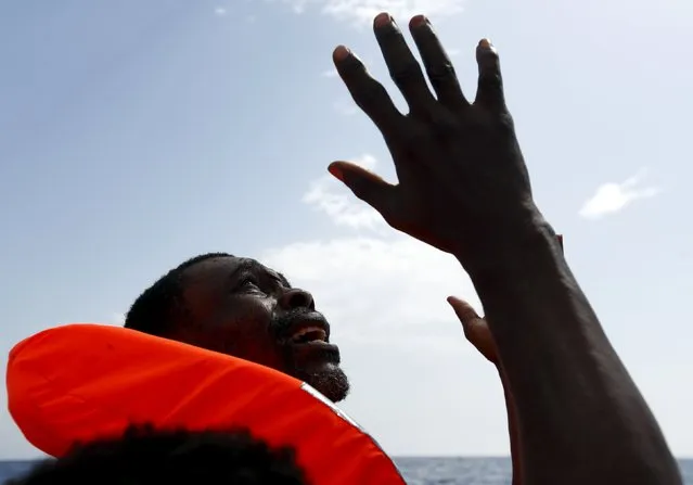 A migrant, who has just been rescued, prays on a Migrant Offshore Aid Station (MOAS) RHIB (Rigid-hulled inflatable boat) whilst being taken to the MOAS ship MV Phoenix, some 20 miles (32 kilometres) off the coast of Libya, August 3, 2015. (Photo by Darrin Zammit Lupi/Reuters)