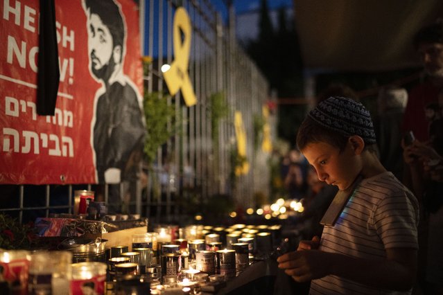 People light candles during a vigil in memory of slain hostage Hersh Goldberg-Polin in Jerusalem, Israel, Sunday, September 1, 2024. (Photo by Leo Correa/AP Photo)