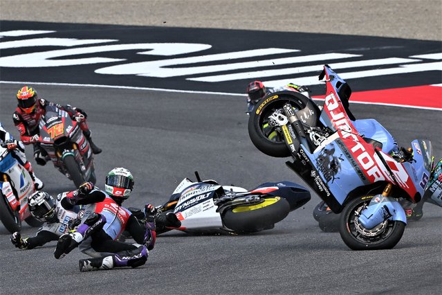 Riders crash during the Italian Moto2 Grand Prix race at Mugello Circuit in Mugello, on June 11, 2023. (Photo by Filippo Monteforte/AFP Photo)