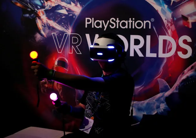 People try the new Sony VR headset during Sony Corporation's PlayStation 4 E3 2016 event in Los Angeles, California, U.S. June 13, 2016. (Photo by Mike Blake/Reuters)