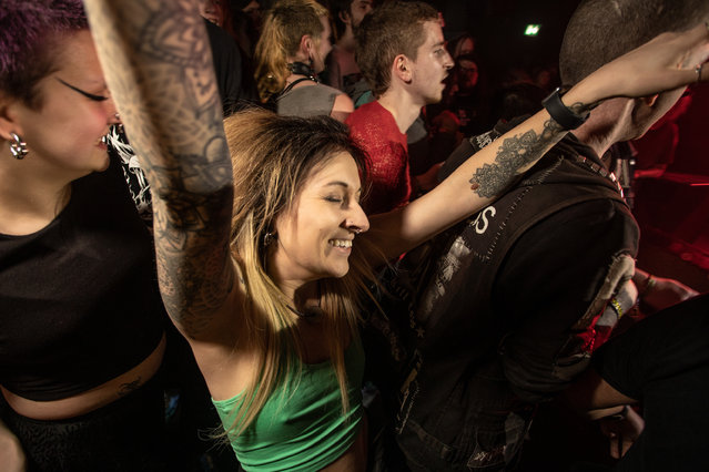 A punk throws her arms in the air in jubilation during Corrupt Vision’s set at The Bread Shed at Manchester Punk festival in Manchester, northern England in the last decade of March 2024. (Photo by Chris Bethell/The Guardian)