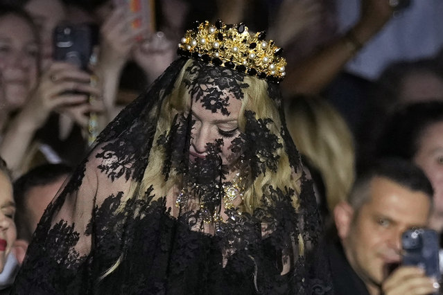 American singer Madonna stands at the end of the Dolce & Gabbana Spring Summer 2025 fashion show, that was presented in Milan, Italy, Saturday, September 21, 2024. (Photo by Antonio Calanni/AP Photo)