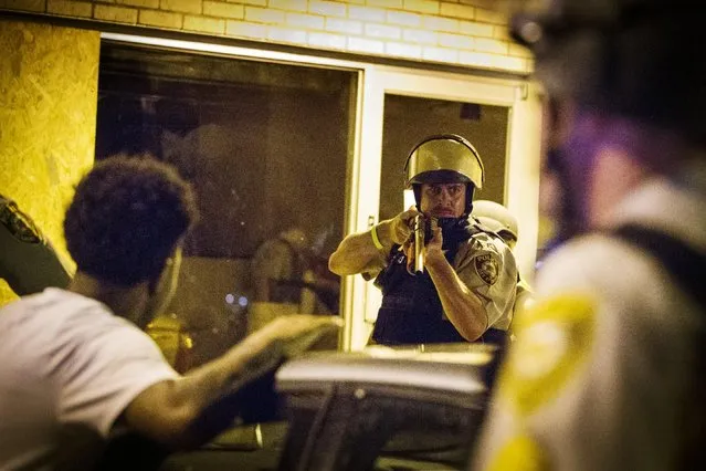 St Louis County police officers arrest an anti-police demonstrator in Ferguson, Missouri August 11, 2015. (Photo by Lucas Jackson/Reuters)