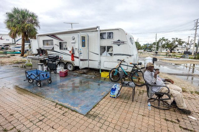 “Smoky” (79), waits for a truck to help him move his mobile home to a safer place in San Carlos Island, Fort Myers beach, as the city prepares for Hurricane Milton in Bonita Beach, Florida, USA, 08 October 2024. According to the National Hurricane Center's Live Hurricane Tracker, Hurricane Milton is set to make landfall on the west coast of Florida on the evening of 09 October. After rapidly intensifying into a Category 5 storm on 07 October, Milton is expected to weaken as it reaches shore but will still bring significant weather impacts across the state. (Photo by Cristóbal Herrera/EPA/EFE)