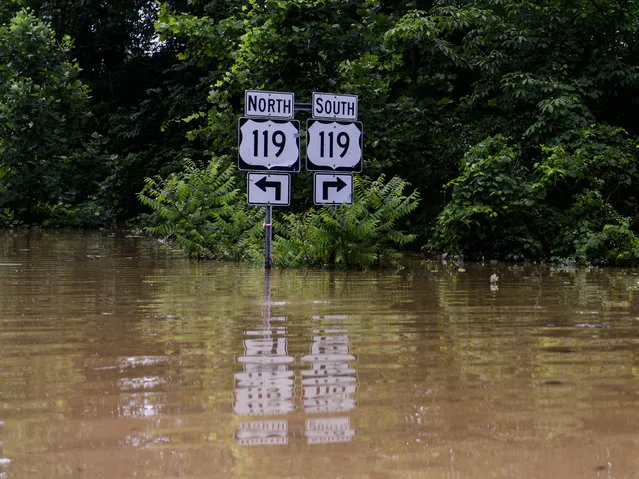 Road signs signaling to US 119 along Frame Road in Elkview, W.Va., are surrounded by flood waters Friday, June 24, 2016. (Photo by Sam Owens/Charleston Gazette-Mail via AP Photo)