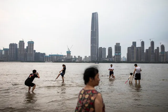 Residents plays in the flooded Jiangtan park caused by Yangtze river on June 10, 2022 in Wuhan, Hubei province, China. According to local media reports, Wuhan has implemented a 72-hour effective system for residents. Life for residents is gradually returning to normal. (Photo by Getty Images)