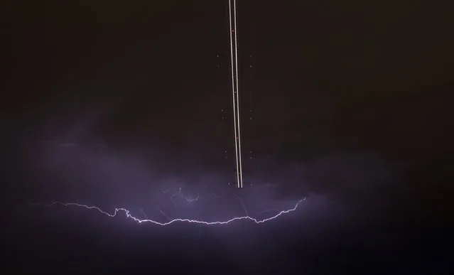 A jet aircraft takes off as lightning strikes across the sky during a monsoon storm at McCarran International Airport in Las Vegas, Nevada July 7, 2014. (Photo by Gene Blevins/Reuters)