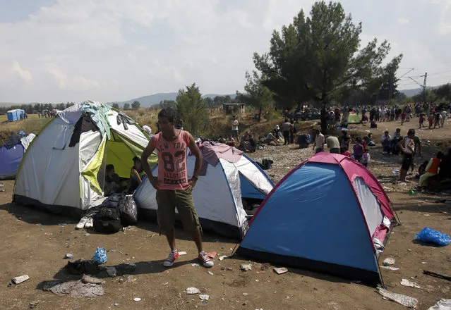 Blocked migrants wait at no-man's land between Greece and Macedonia near the southern Macedonian town of Gevgelija, Thursday, August 20, 2015. (Photo by Darko Vojinovic/AP Photo)