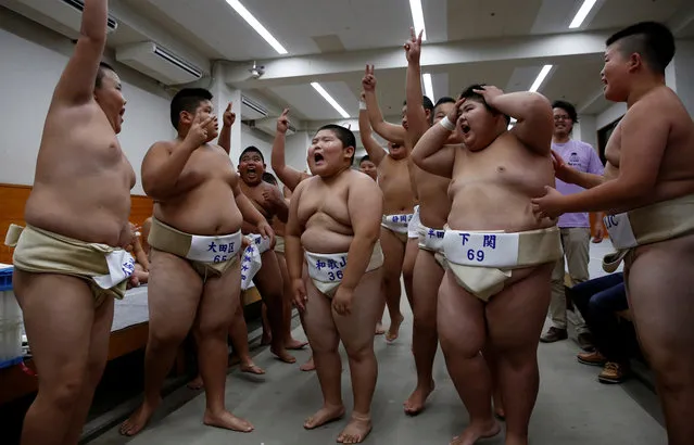 Elementary school sumo wrestlers react as they apply for having TV interview after their matches during the Wanpaku sumo-wrestling tournament in Tokyo, Japan July 30, 2017. (Photo by Kim Kyung-Hoon/Reuters)