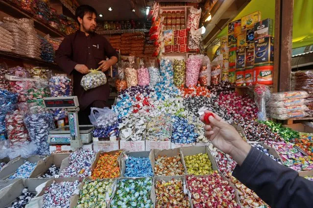People shop for festive goodies in preparation for Eid al-Fitr in Kabul, Afghanistan July 4, 2016. (Photo by Omar Sobhani/Reuters)