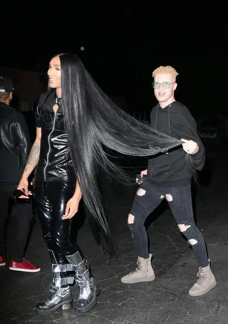 Shaun Ross takes time to admire some truly impressive hair extensions as he arrives at the Tings Magazine party at Nightingale Plaza. Los Angeles, California on Wednesday, August 23, 2017. (Photo by MHD/PacificCoastNews)