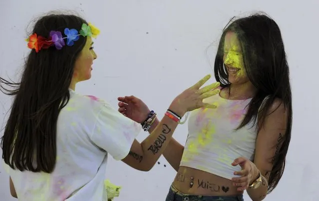 Revellers take part in the Holi Party Festival at the Niemeyer Center in Aviles, northern Spain, August 29, 2015. (Photo by Eloy Alonso/Reuters)