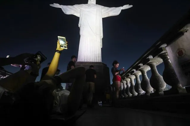Visitors gather and take pictures at dusk at the famed Christ the Redeemer statue on September 14, 2017 in Rio de Janeiro, Brazil. Rio de Janeiro's hotels have reported a fifty percent drop in expected reservations for the upcoming New Year's and Carnival holidays. Factors include the economic crisis in Brazil, a spike in urban crime and violence and an expanded number of hotel rooms constructed in the run up to the Olympics. (Photo by Mario Tama/Getty Images)