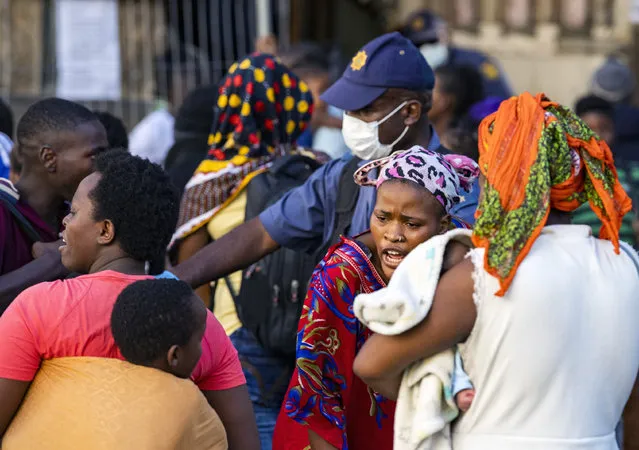 Police remove foreign migrants from the Central Methodist Church in Cape Town, Sourth Africa, Thursday, April 2, 2020. The migrants, who had been sheltering there for months, refused to leave the church and had previously demanded that South Africa relocate them to other countries, including the United States and Canada, because they had been victims of xenophobic threats in South Africa last year. (Photo by AP Photo/Stringer)