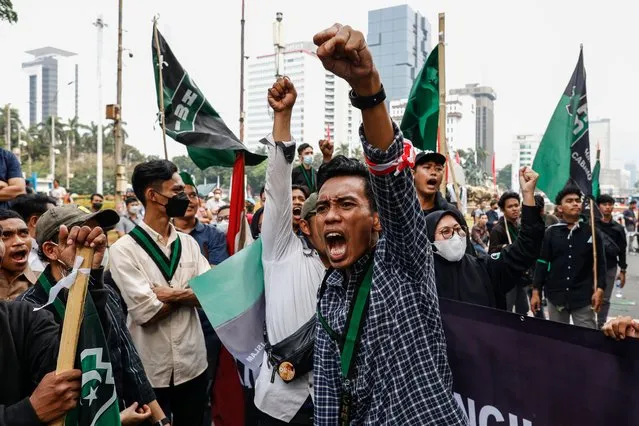 Students shout slogans during a protest against the government's plan to cut fuel subsidies, outside the main gate of the parliament building in Jakarta, Indonesia, 29 August 2022. The Indonesian government is planning a price adjustment to reduce fuel subsidies into the state budget, following an increase in oil prices worldwide. (Photo by Mast Irham/EPA/EFE/Rex Features/Shutterstock)